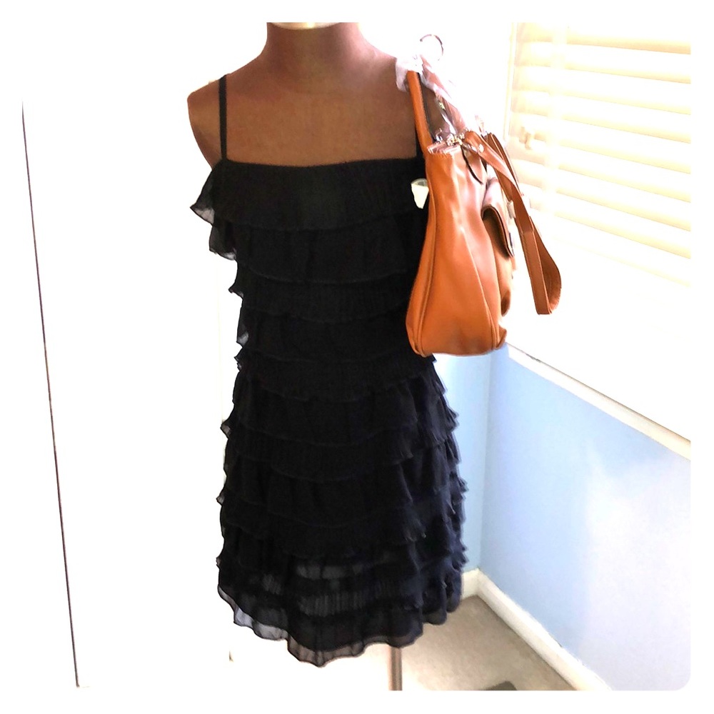 A black ruffle cocktail dress with accessories